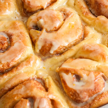 Fluffy eggless cinnamon rolls made with fresh orange, topped with an orange glaze!