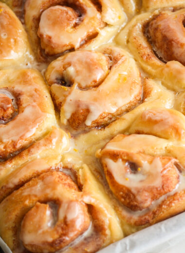 Fluffy eggless cinnamon rolls made with fresh orange, topped with an orange glaze!