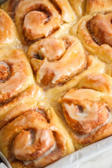 Fluffy eggless cinnamon rolls made with fresh orange, topped with an orange glaze!
