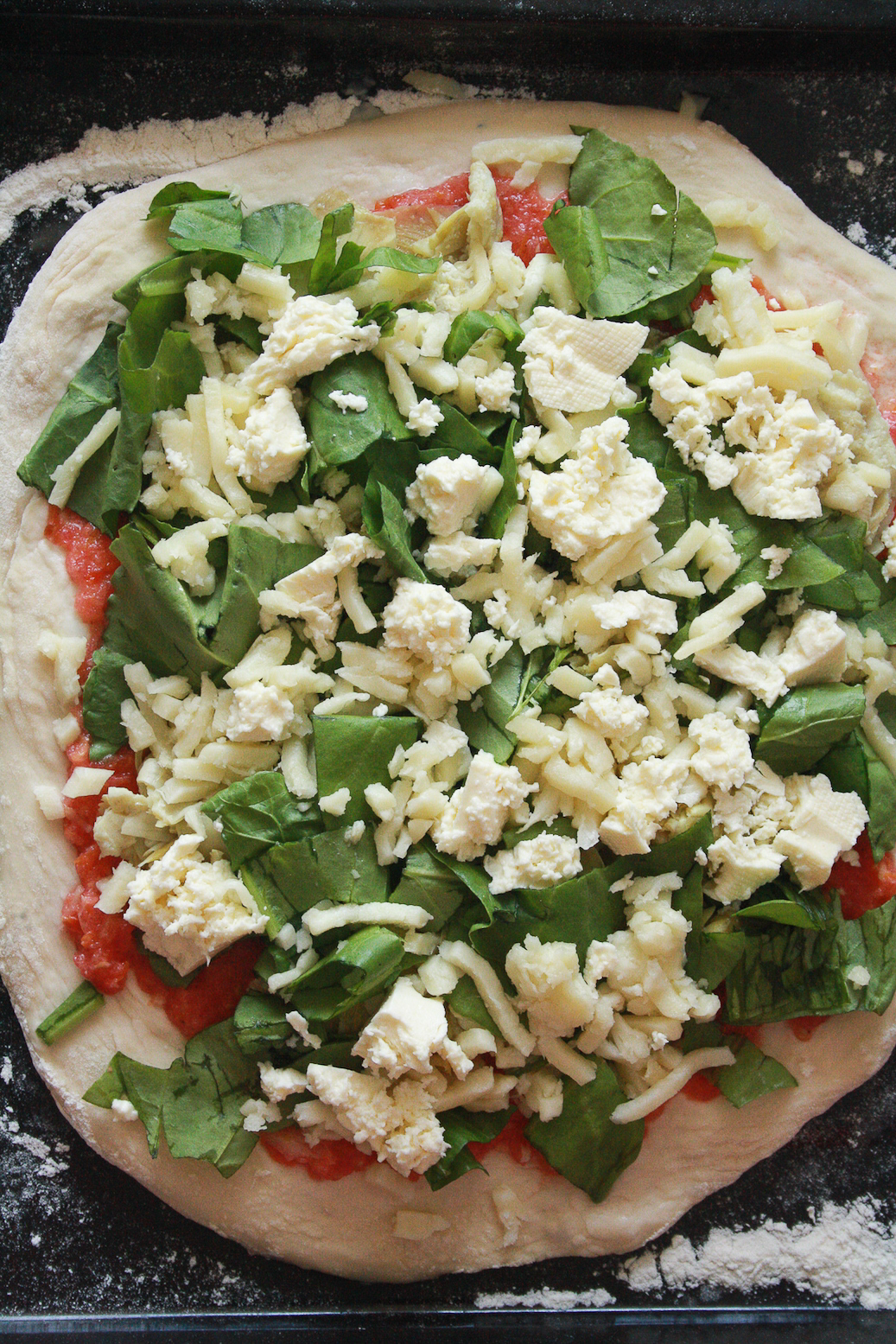 A chewy, deeply flavoured pizza crust topped with a simple tomato sauce, spinach and artichokes, plus lots of cheese!
