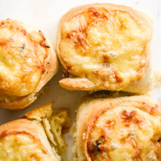 Soft and fluffy savoury rolls filled with cheddar cheese and caramelised onions!