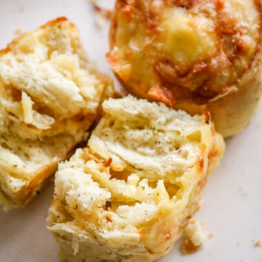 Soft and fluffy savoury rolls filled with cheddar cheese and caramelised onions!