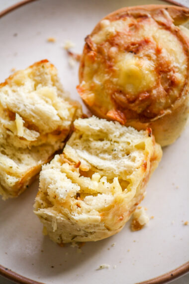 Soft and fluffy savoury rolls filled with cheddar cheese and caramelised onions!