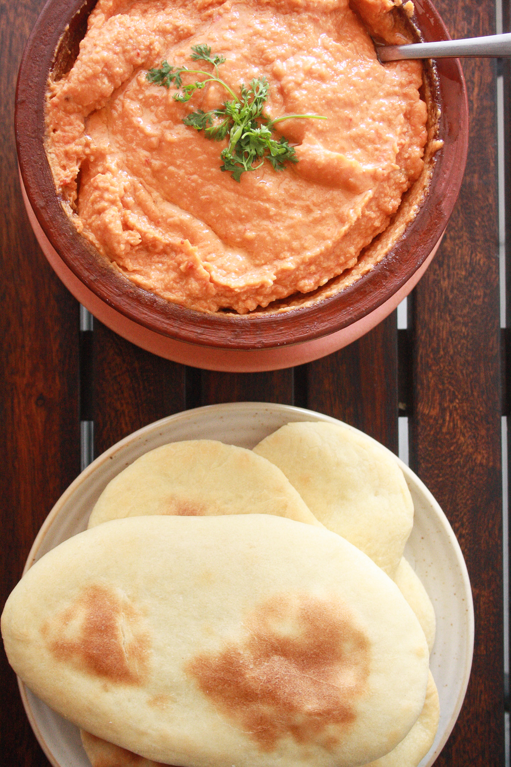 Classic hummus taken up a notch with juicy roasted peppers, served with soft and fluffy homemade pita!