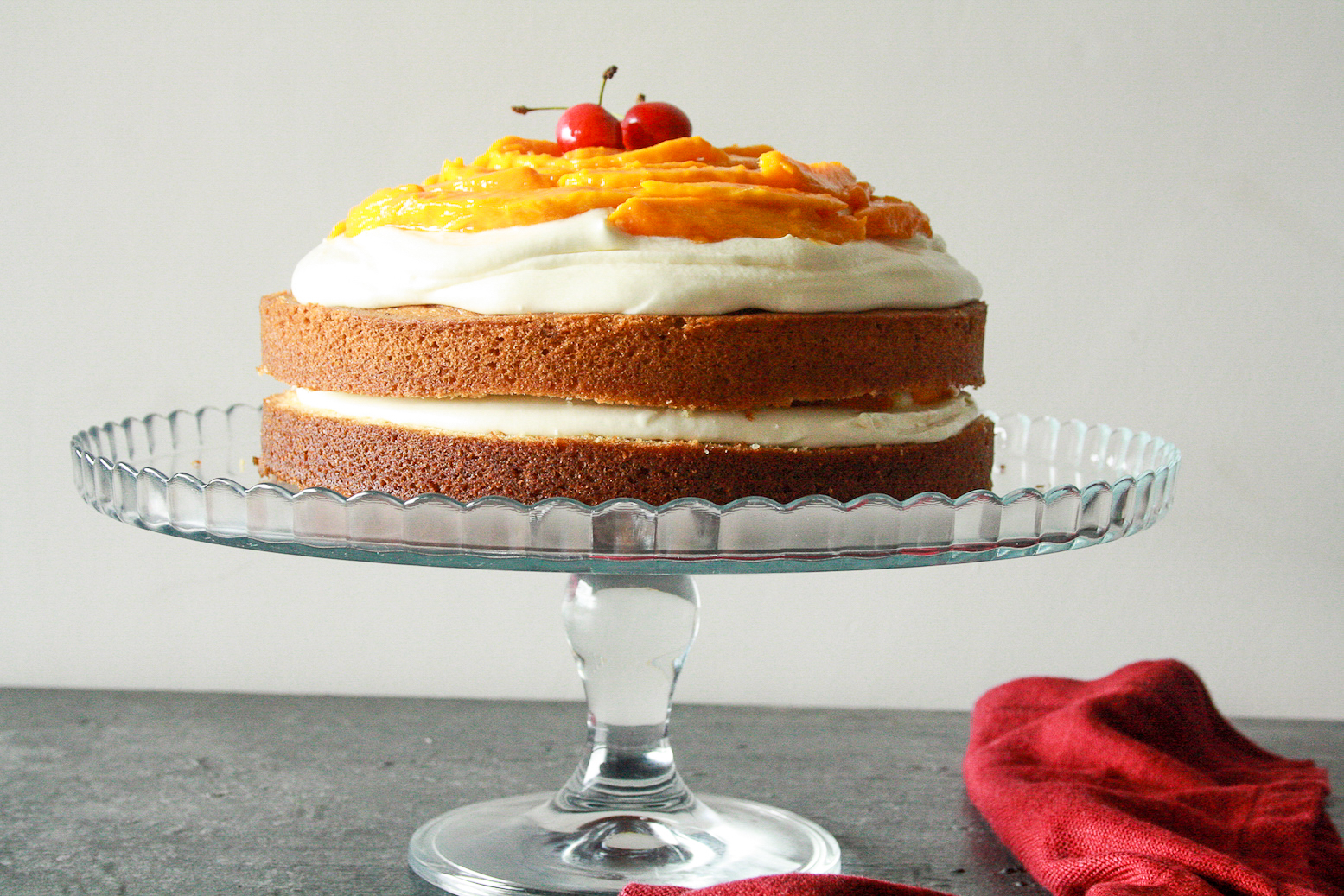 A classic, buttery, tender cake layered with tangy cream cheese frosting and lots of fresh mangoes!
