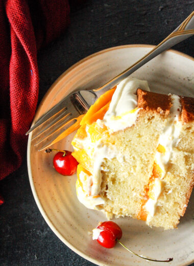 A classic, buttery, tender cake layered with tangy cream cheese frosting and lots of fresh mangoes!