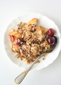 Fresh peaches and cherries with a delicious coconut oat topping make this vegan, gluten-free crisp the perfect summer dessert!