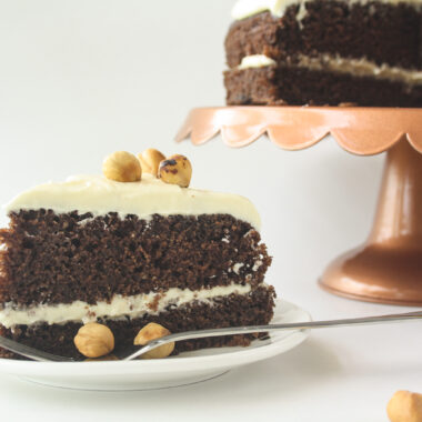 Moist chocolate cake filled with hazelnuts, layered with a hazelnut cream cheese frosting!