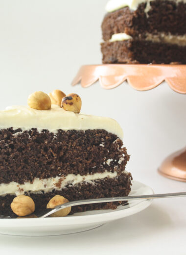 Moist chocolate cake filled with hazelnuts, layered with a hazelnut cream cheese frosting!