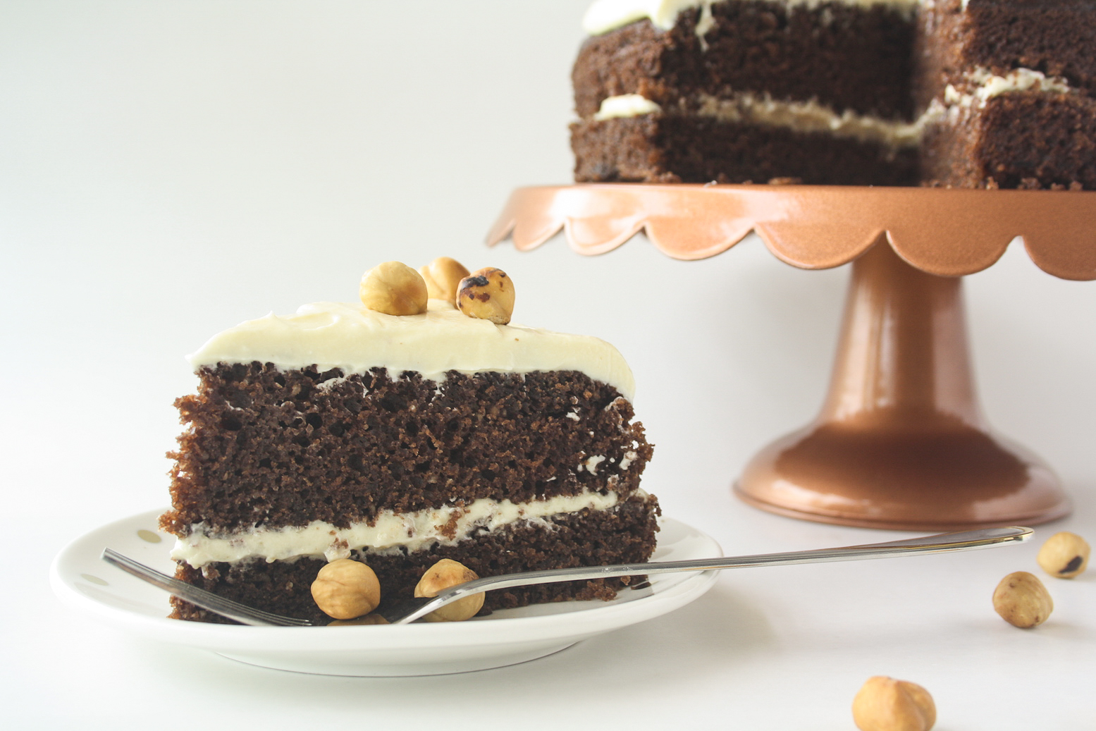 Moist chocolate cake filled with hazelnuts, layered with a hazelnut cream cheese frosting!