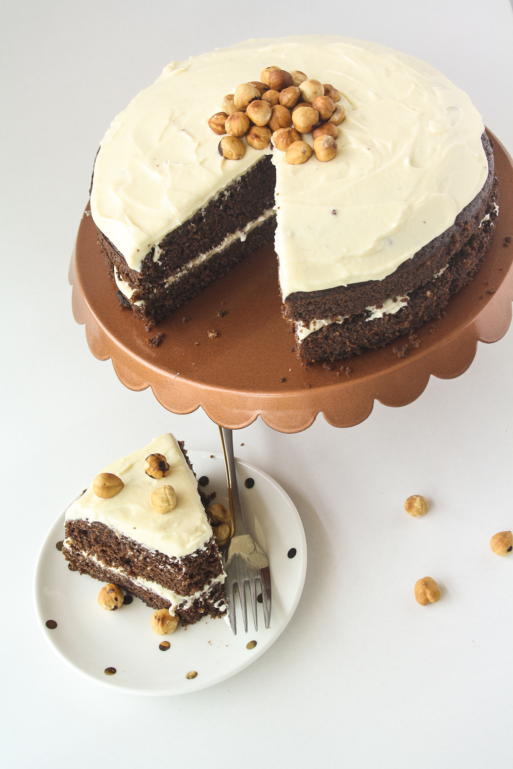 Moist chocolate cake filled with hazelnuts, layered with a hazelnut cream cheese frosting!