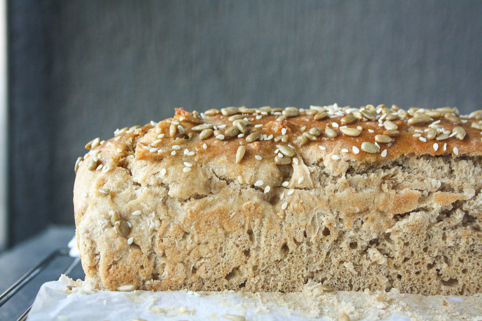 Soft and chewy homemade rye bread topped with sesame and sunflower seeds.