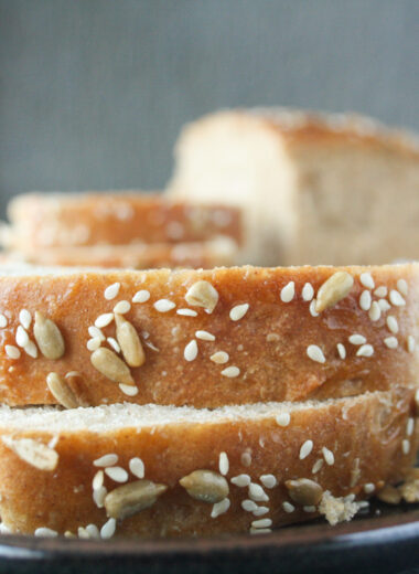 Soft and chewy homemade rye bread topped with sesame and sunflower seeds.