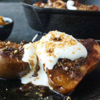 Soft, juicy, spiced baked pears stuffed with hazelnut praline and topped with cream!
