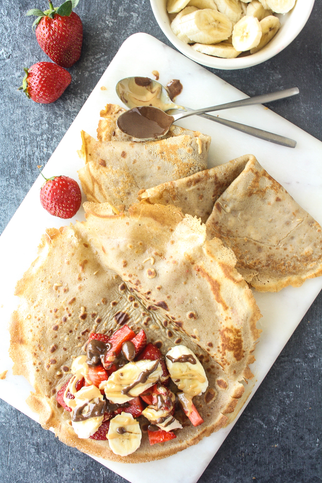 Super quick buckwheat crepes, easily made vegan, and filled with fresh fruit and nut butters!
