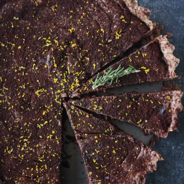 Rich chocolate tart infused with orange and rosemary, on a buttery flaky crust!