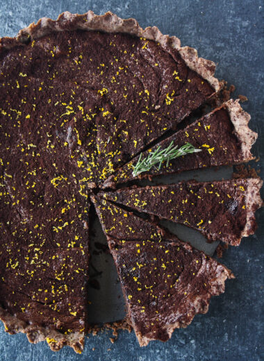 Rich chocolate tart infused with orange and rosemary, on a buttery flaky crust!