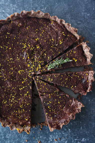 Rich chocolate tart infused with orange and rosemary, on a buttery flaky crust!