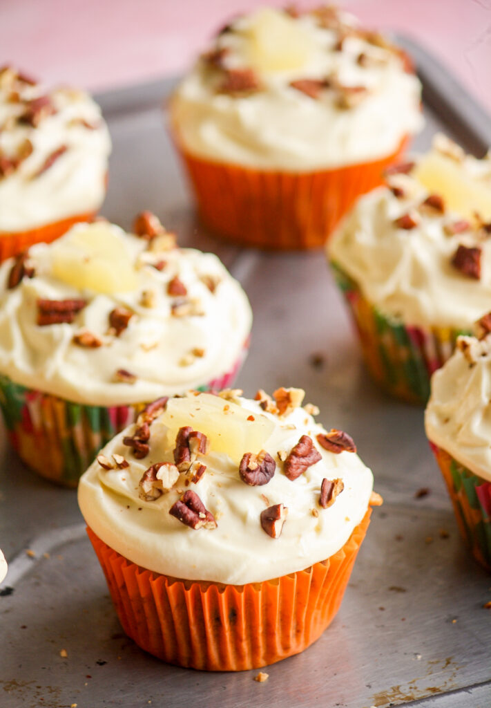 Moist and fruity banana, pineapple and coconut cupcakes with pecans and cream cheese frosting!