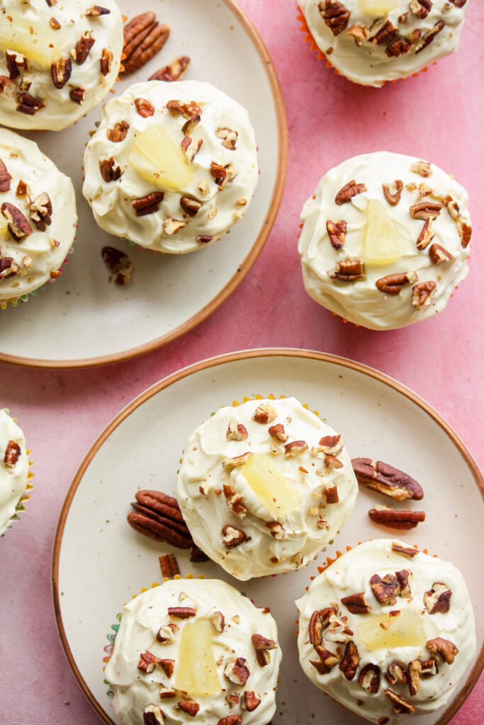 Moist and fruity banana, pineapple and coconut cupcakes with pecans and cream cheese frosting!