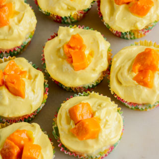 Soft, moist cupcakes with coconut, topped with a mango cream cheese frosting