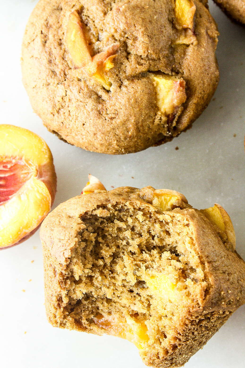 Tender brown sugar muffins made with cornmeal and fresh peaches!