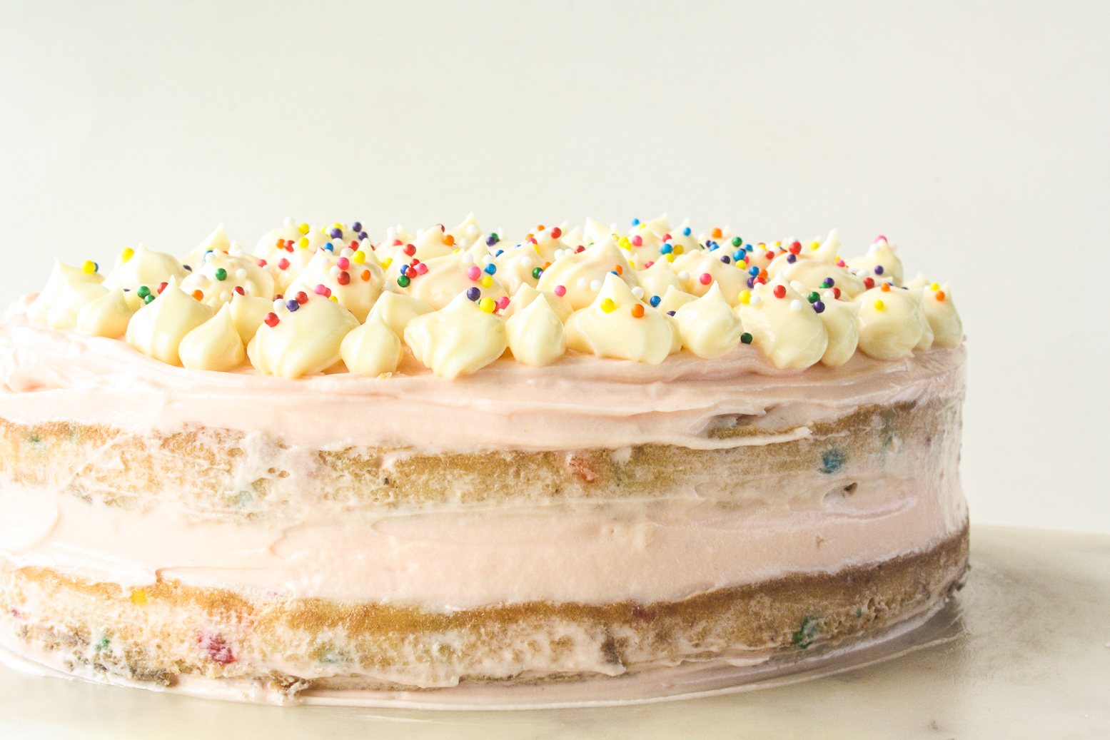 Buttery layer cake with sprinkles and pink frosting!