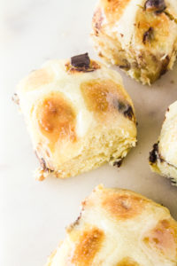 Soft and buttery hot cross buns with orange zest and chocolate chips