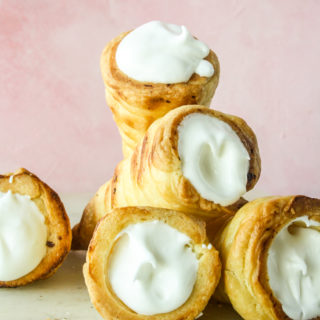 Homemade all-butter puff pastry rolls filled with vanilla whipped cream