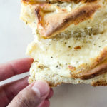 A soft and buttery pull-apart bread with a garlicky cream cheese and cheddar filling!