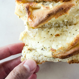 A soft and buttery pull-apart bread with a garlicky cream cheese and cheddar filling!