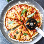 Homemade wholewheat pizza dough with tomato sauce and mozzarella for a classic margherita