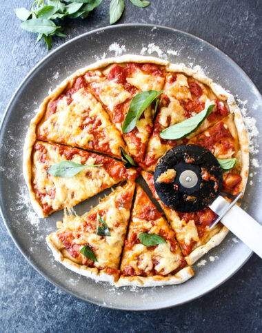Homemade wholewheat pizza dough with tomato sauce and mozzarella for a classic margherita