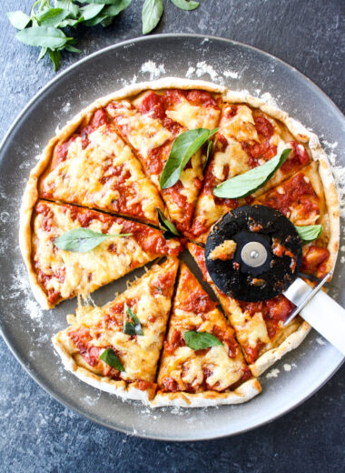 Homemade wholewheat pizza dough with tomato sauce and mozzarella for a classic margherita