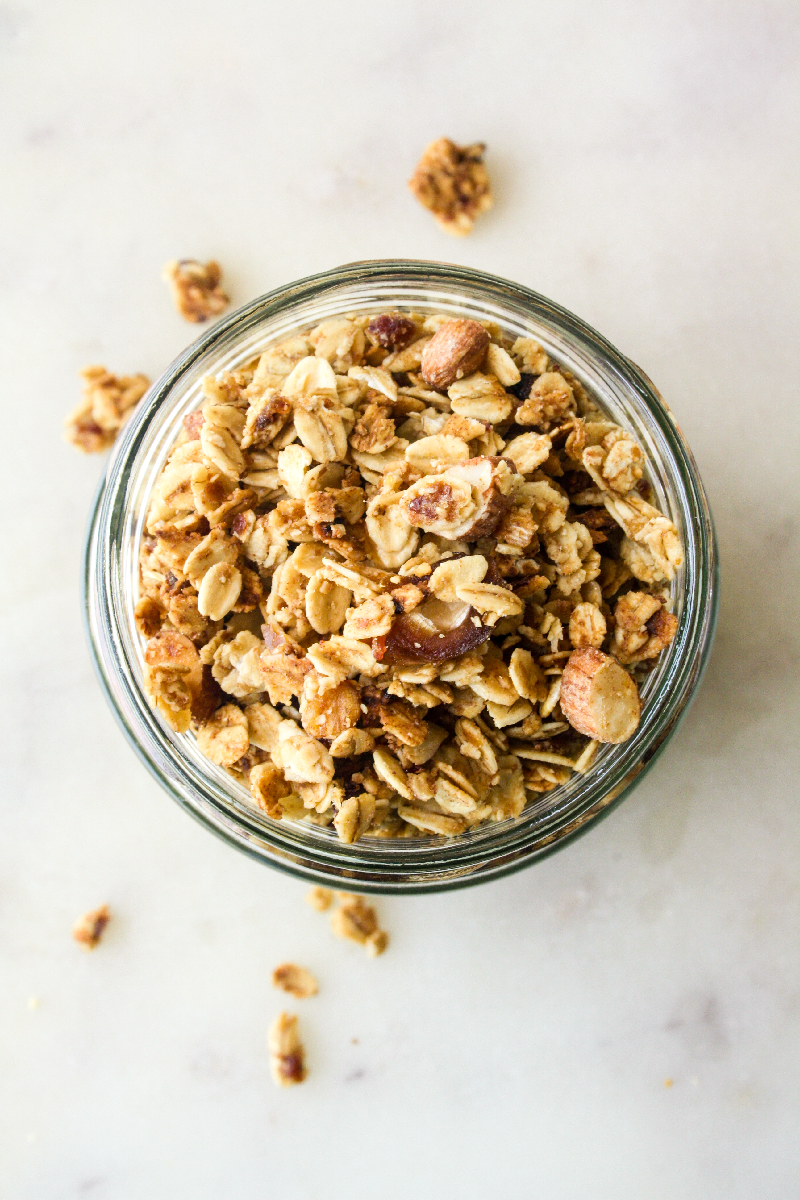Crunchy vegan, gluten-free date and almond granola with yoghurt, bananas and cherries