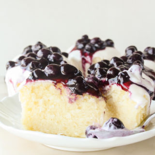 Moist lemon cakes with tangy cream cheese icing and blueberry compote