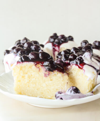 Moist lemon cakes with tangy cream cheese icing and blueberry compote