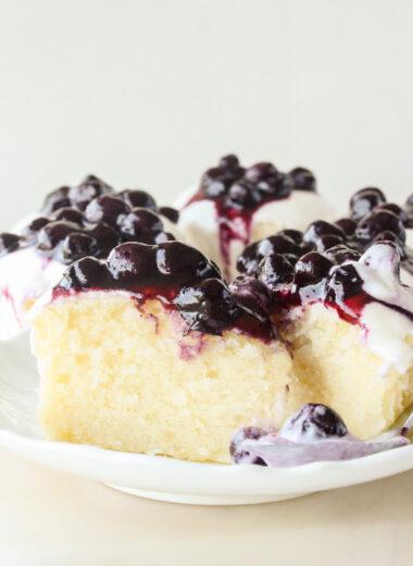 Moist lemon cakes with tangy cream cheese icing and blueberry compote