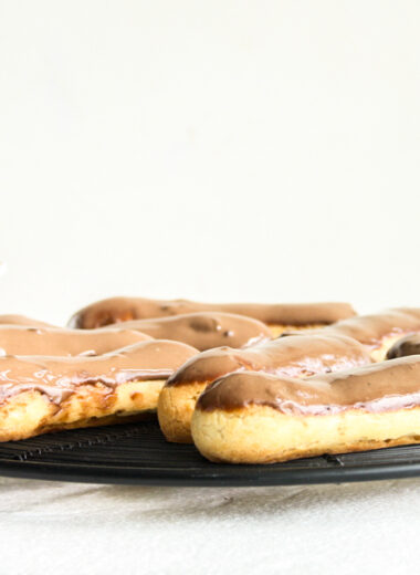 Eclairs with homemade choux pastry, filled with whipped cream and topped with chocolate ganache