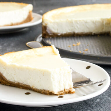 Classic, creamy, tangy New York baked cheesecake with a buttery biscuit base