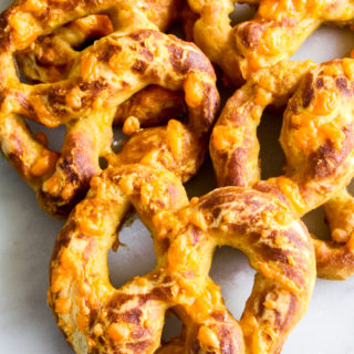 Soft and chewy homemade pretzels with orange cheddar and garlic
