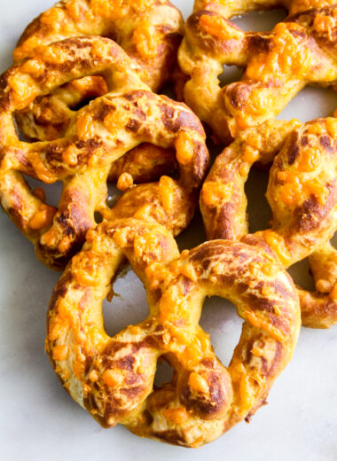 Soft and chewy homemade pretzels with orange cheddar and garlic