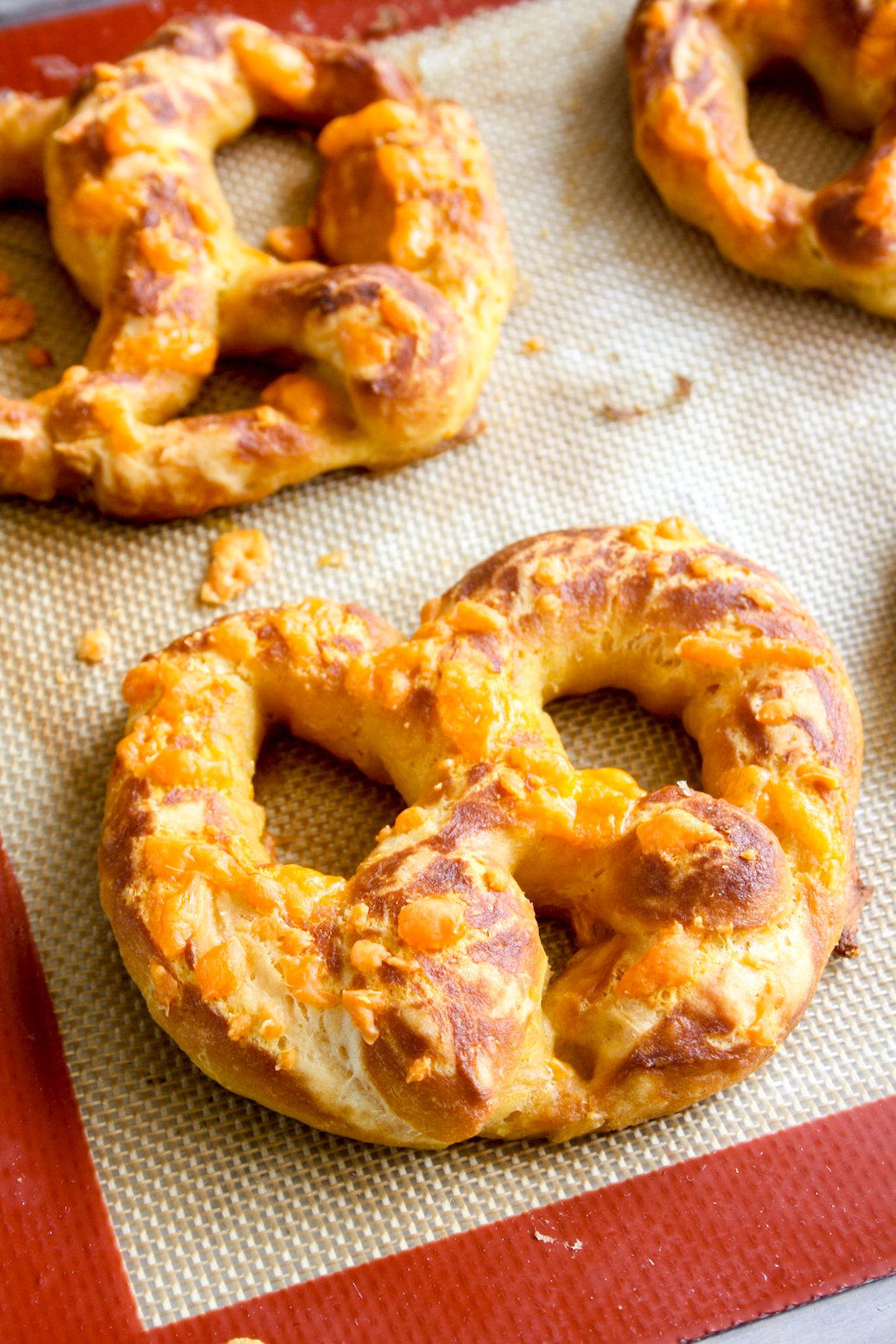 Soft and chewy homemade pretzels with orange cheddar and garlic