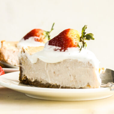 Smooth, creamy baked cheesecake with strawberries in the filling and on top!