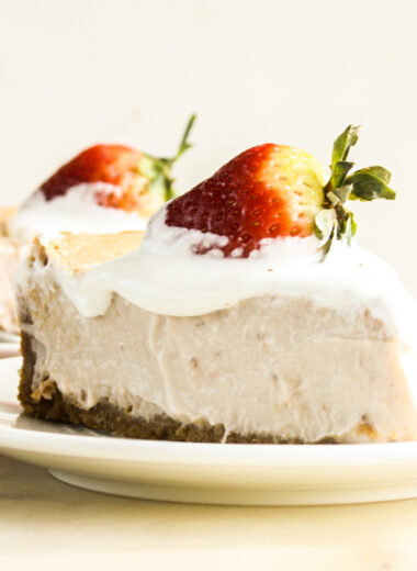 Smooth, creamy baked cheesecake with strawberries in the filling and on top!