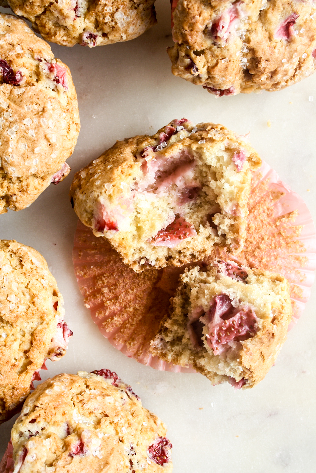 Soft, crispy-topped muffins with fresh strawberry pieces