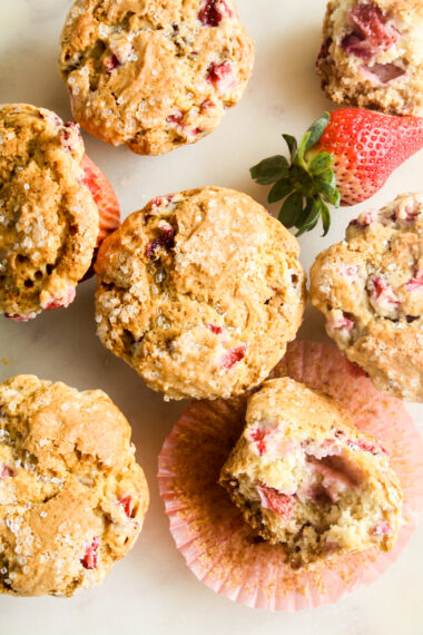 Soft, crispy-topped muffins with fresh strawberry pieces