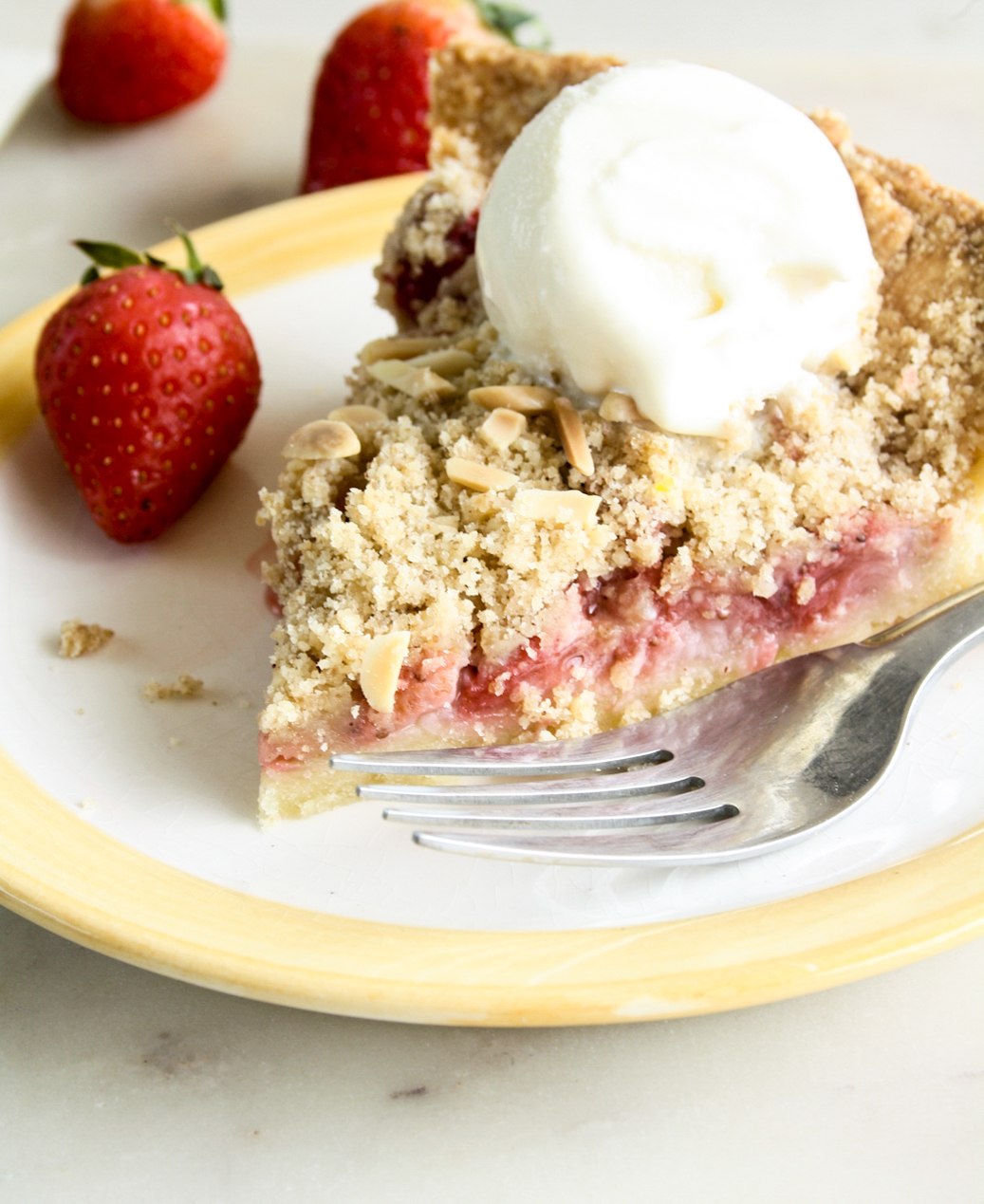 Juicy strawberries on homemade pie crust with a crunchy crumble topping