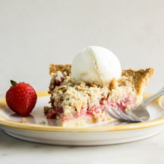 Juicy strawberries on homemade pie crust with a crunchy crumble topping