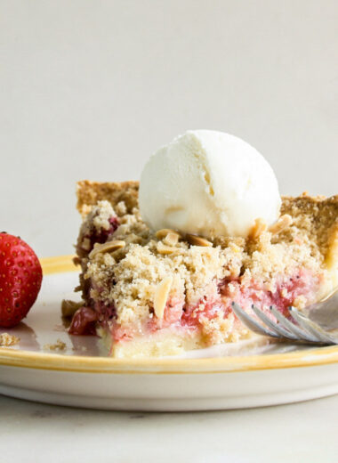 Juicy strawberries on homemade pie crust with a crunchy crumble topping